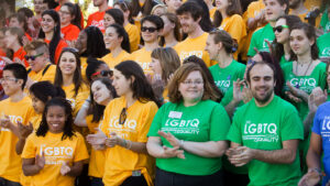 A crowd of people wear LGBTQ Equality shirts