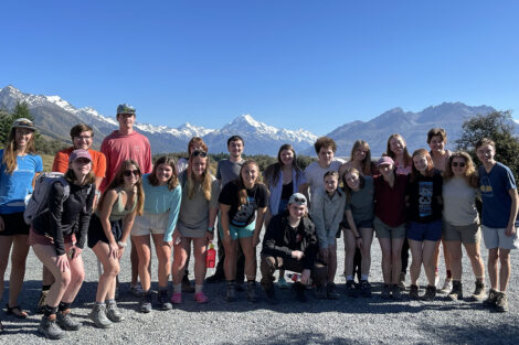 The group smiles at Mount Cook.