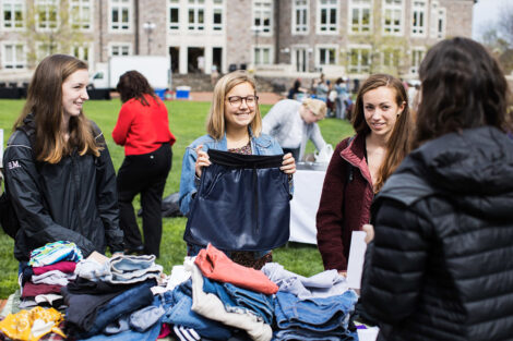 Students shop for clothes at the outdoor thrift shop.