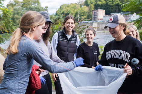 A group of students pick up trash.