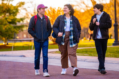 Three students walk across the Quad on Founders' Day.