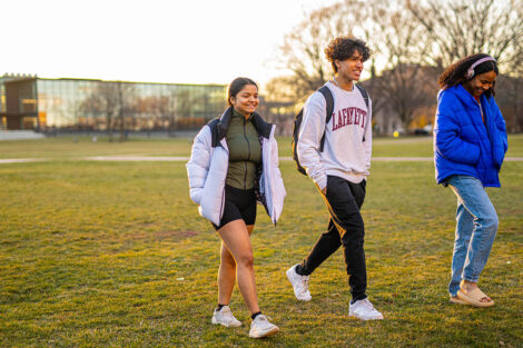 Three students walk across the Quad during Founders' Day