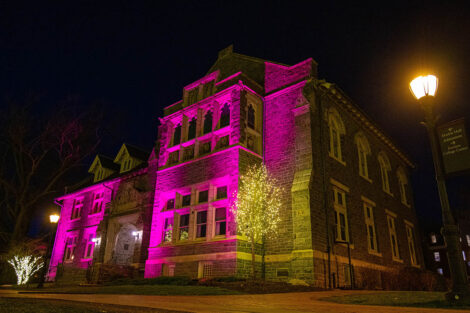 Hogg Hall in maroon lights during Founders' Day