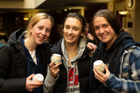 Students smiling, holding cups of ice cream during Founders' Day.