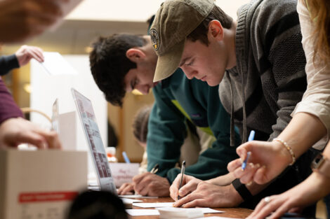Students sign thank you cards during Founders' Day.
