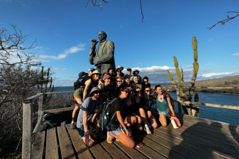 Students pose with a statue of Charles Darwin on San Cristóbal Island at the supposed site of HMS Beagle’s first landing on the Galapagos.