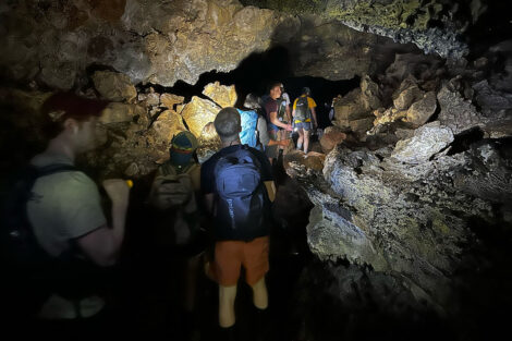 Students Exploring a lava tube on Santa Cruz Island, Galapagos.