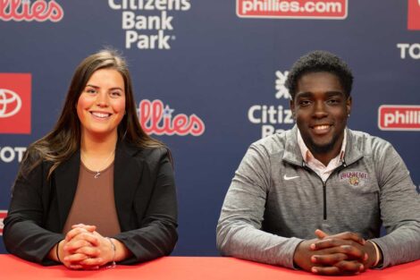 Lafayette students Jean Regnier and Julia Roman sitting in a conference room and smiling during their externship with the Philadelphia Phillies organization