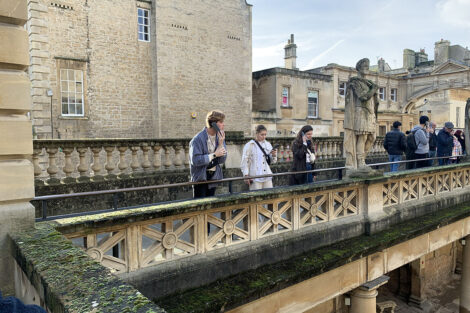 Students stand on a bridge.