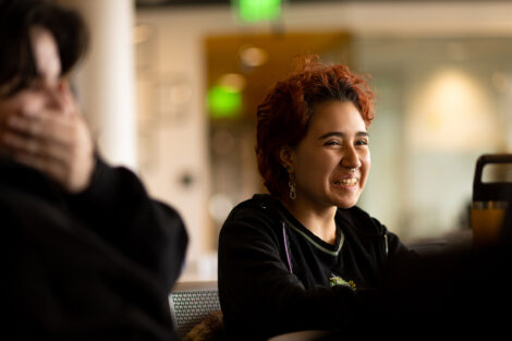 A student smiles in conversation with Simmone Taitt '04.
