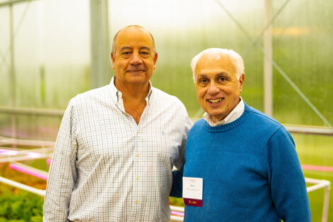 Robert E. Sell '84, chair of the Lafayette Board of Trustees and Harry S. Cherken Jr, Esq. ’71, trustee, stand arm in arm at the new greenhouse at LaFarm