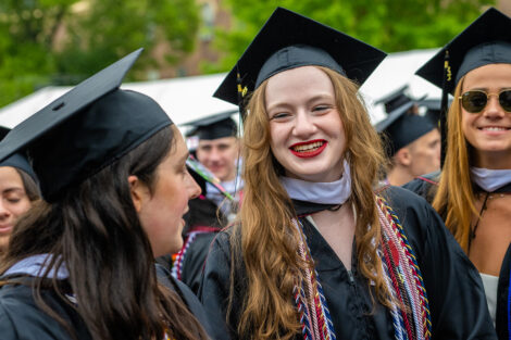 Students smile as they walk toward the Quad.