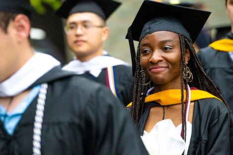 Students smile as they walk toward the Quad.