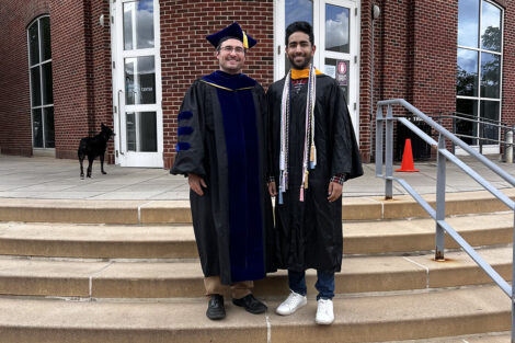 Harshil stands with Prof. Justin Hibes.