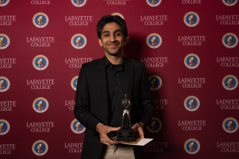 Mujtaba Pal '23 smiles with an award.