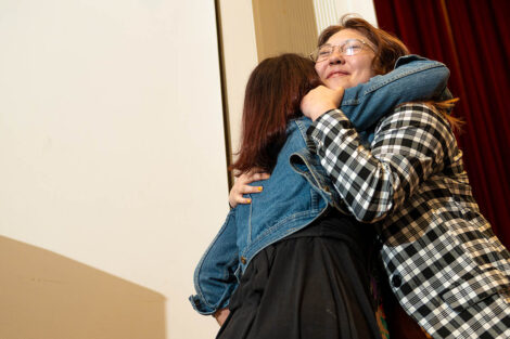 A student hugs a mentor.