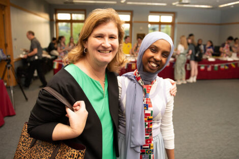 President Nicole Hurd smiles with a student.