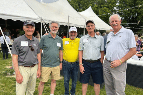Five alumni stand on the quad at Reunion.