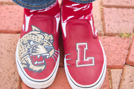 Maroon shoes with the leopard and an L.