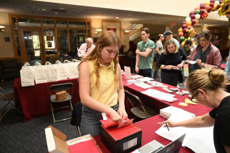 A Lafayette student is working the registration table at Family Weekend.