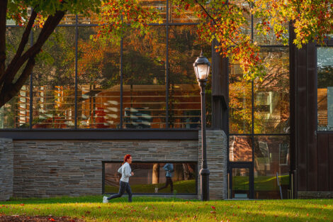 A student jogs in front of Skillman Library.