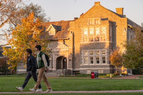 Two students walk together on campus.