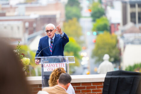 Jeffrey Ruthizer ’62 P’00 is standing at a podium overlooking Easton and is speaking to a crowd.