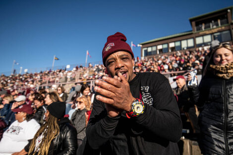 A man in a Lafayette College hat claps in the crowd.