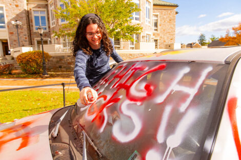 A student spray paints the Lehigh Car.