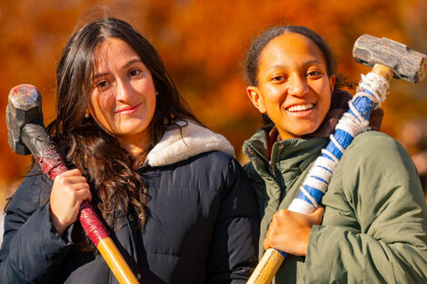 Students smile with sledgehammers.