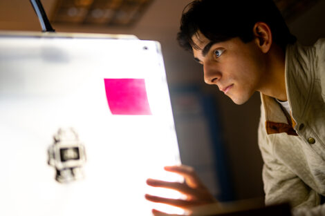 A student's face is illuminated by classroom technology.