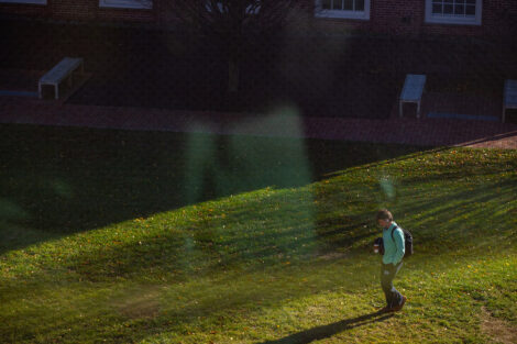 A student walks outdoors.
