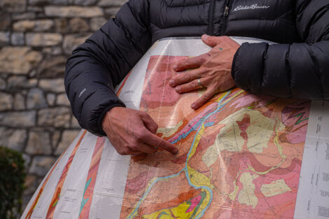David Sunderlin points on a geological map.