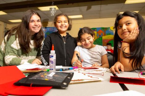 A Lafayette student leads an arts and craft project with three students at Easton Area Community Center.