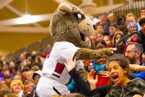 Kids cheer as the Leopard walks through the stands during School Day Game.
