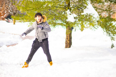 A student prepares to throw a snowball.