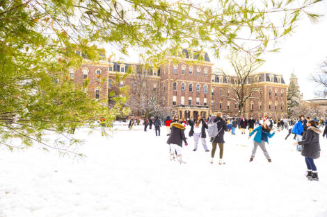 A photo of the Quad featuring students engaging in a friendly snowball fight.