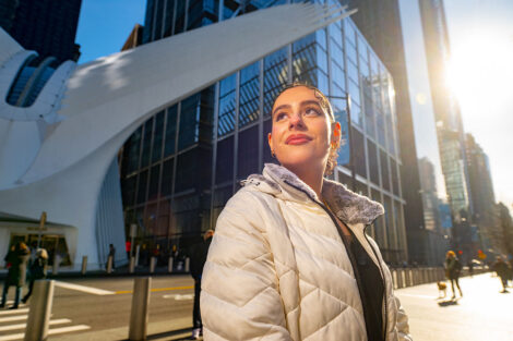 Dina Azar '25 poses in front of a glass building