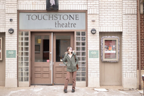 McKenna Graf ’26 poses outside the Touchstone Theatre building.