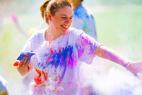A student participates in the Holi Fest.