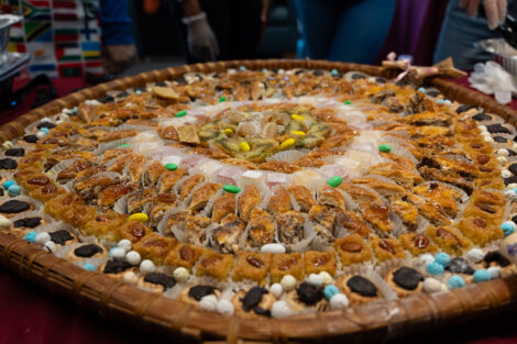 A large plate of assorted foods including Baklava.