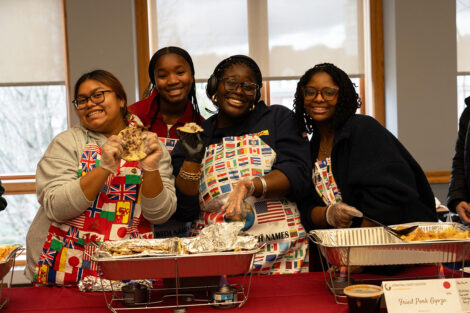 A group of students smile at the ISA food tasting event.