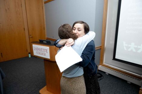 Jodi Fowler hugs a student at the Landis Awards Ceremony
