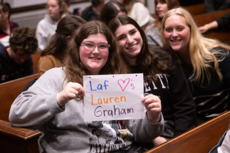 Students smile with a sign that says Laf loves Lauren Graham.