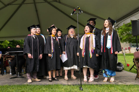 Students sing on stage.
