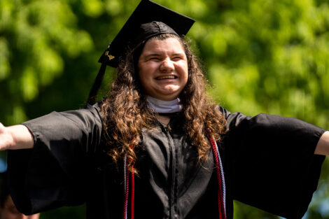 A graduate smiles in excitement.