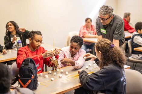 Easton Middle School students work alongside Laf engineering students to construct structures out of spaghetti and marshmallows.