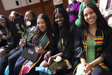 A group of students smile during the Pose graduation.
