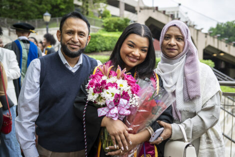 Family members smile with their graduate.