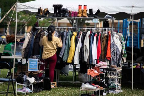 A shopper looks through a rack of coats during the West Ward Sale.